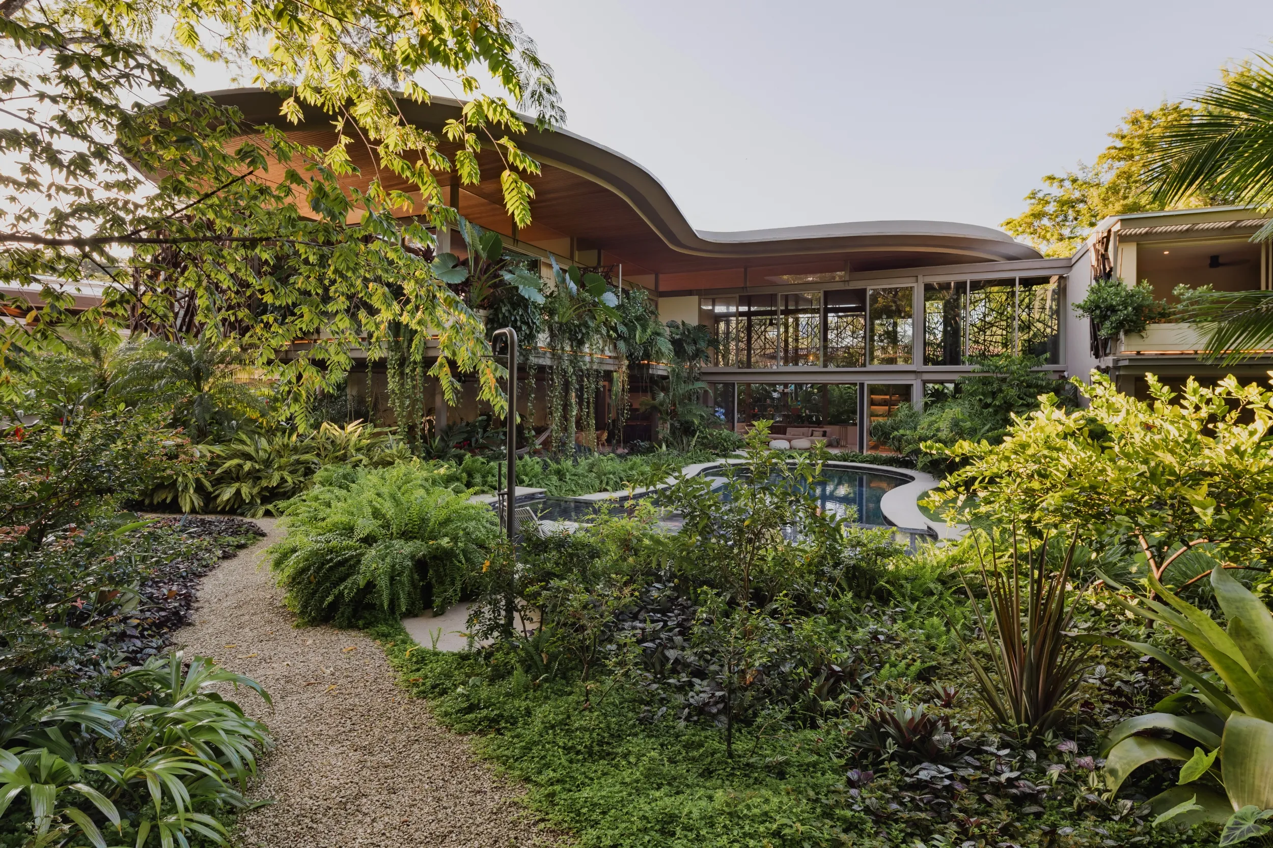 SEN villa curved hardwood roof architecture and tropical garden, Pelada Beach, Nosara, Costa Rica