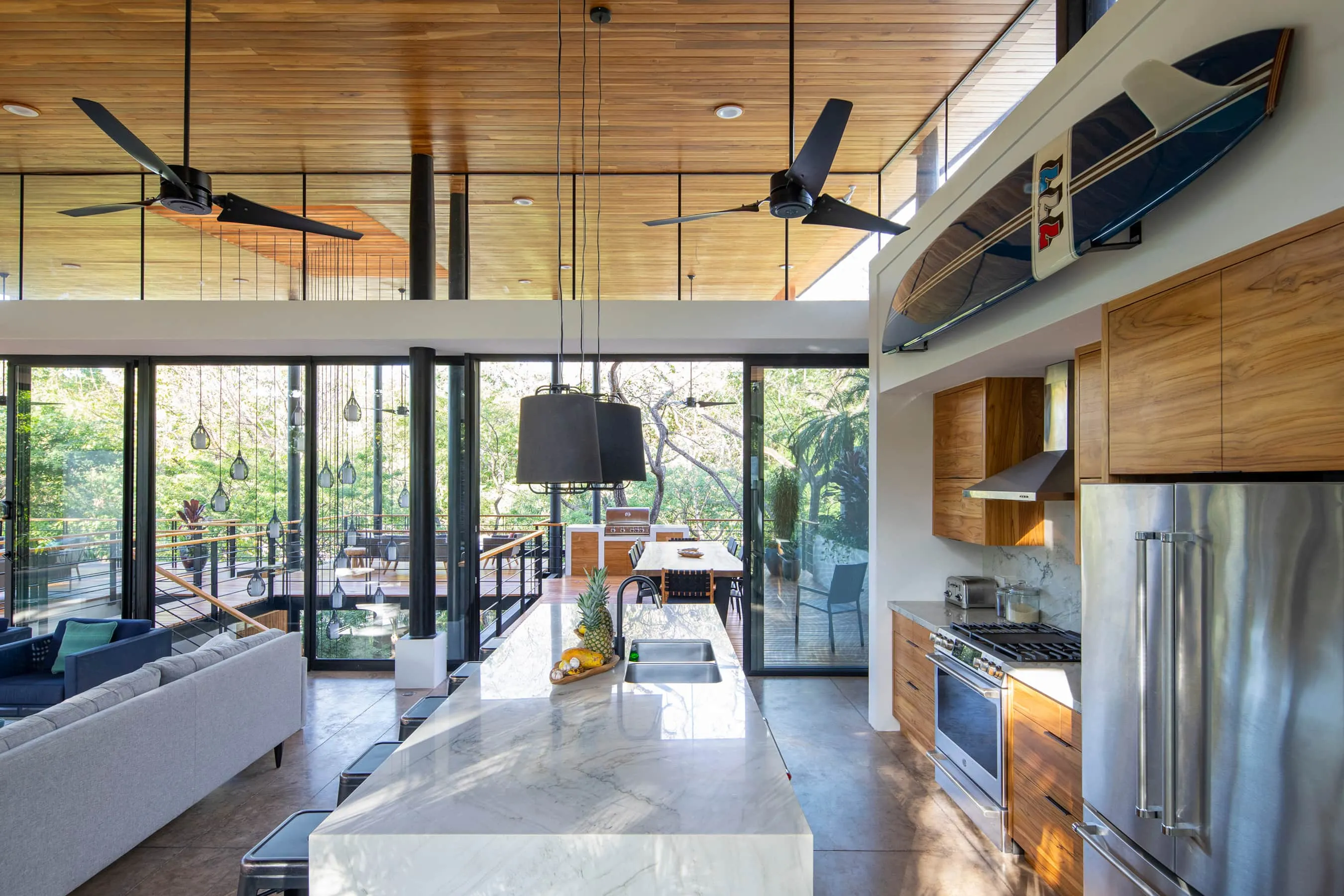 Terrace House villa open living and kitchen with high ceilings and jungle through glass, South Guiones Nosara