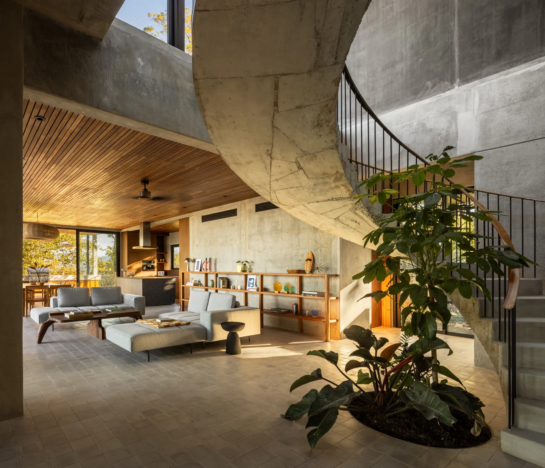 Villa Aravis living room with sculptural spiral staircase, Nosara