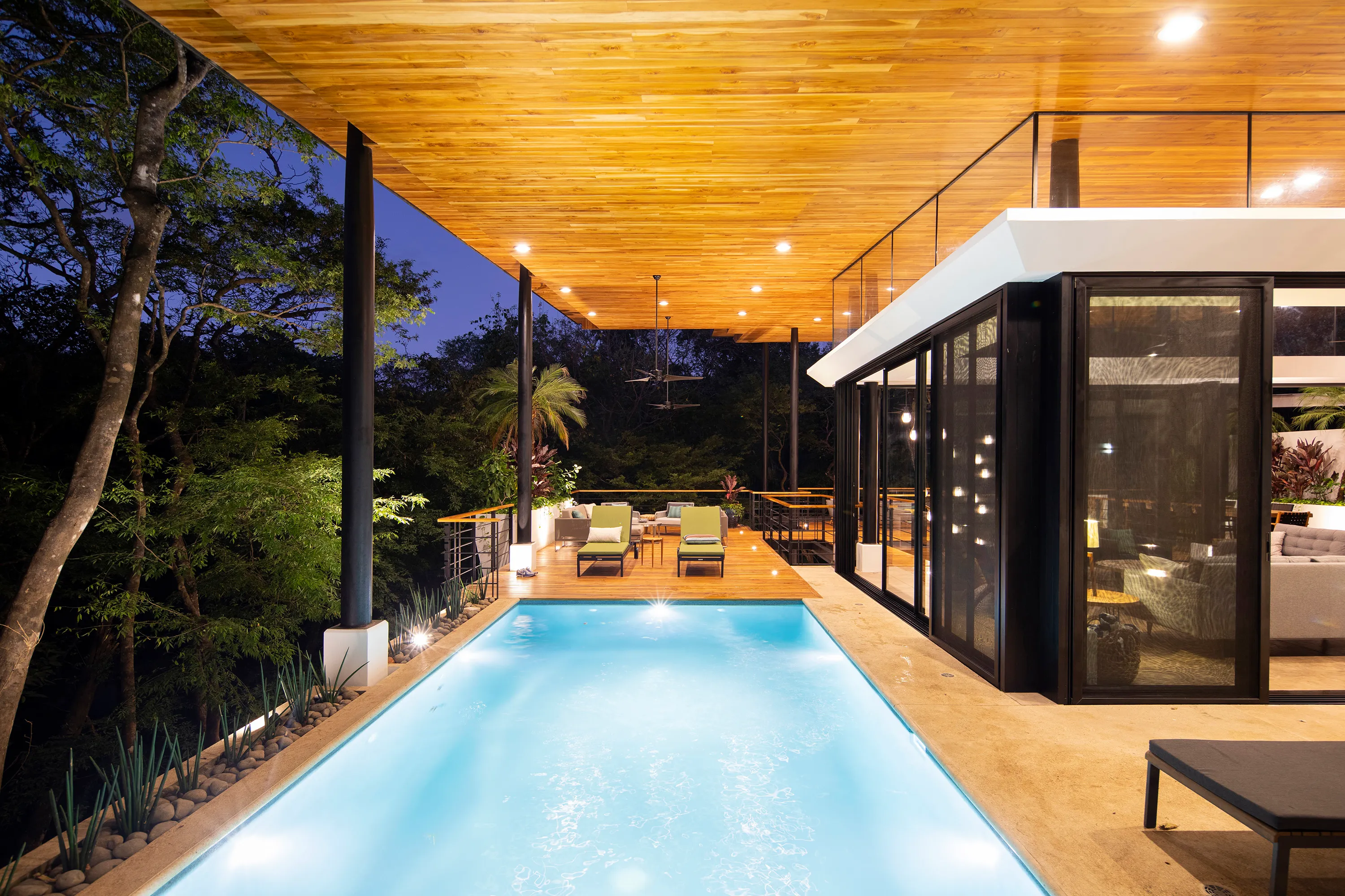 Terrace House villa pool at night with the structure illuminated, Nosara
