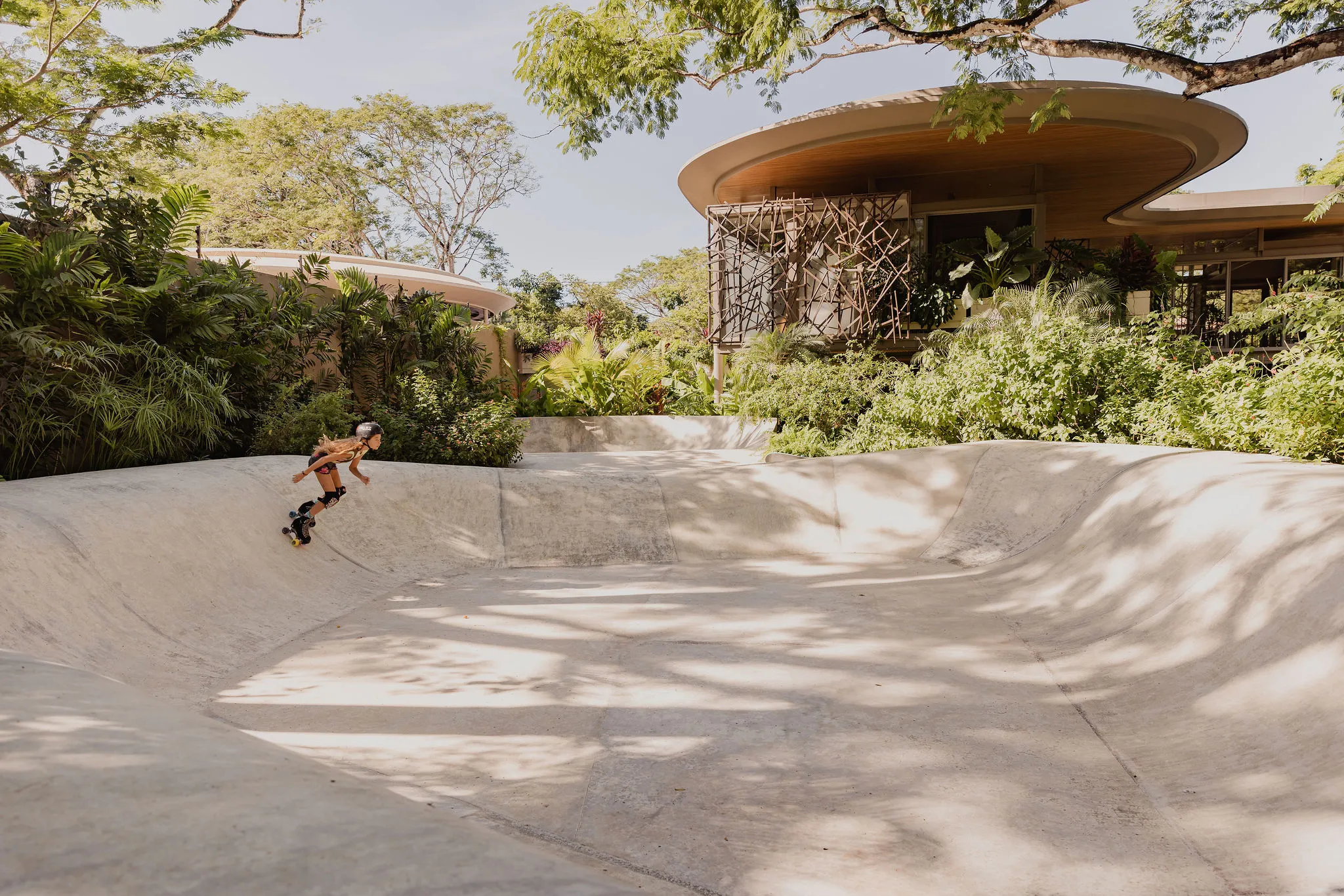 SEN villa private skate bowl with rider carving the transition, Pelada Beach Nosara