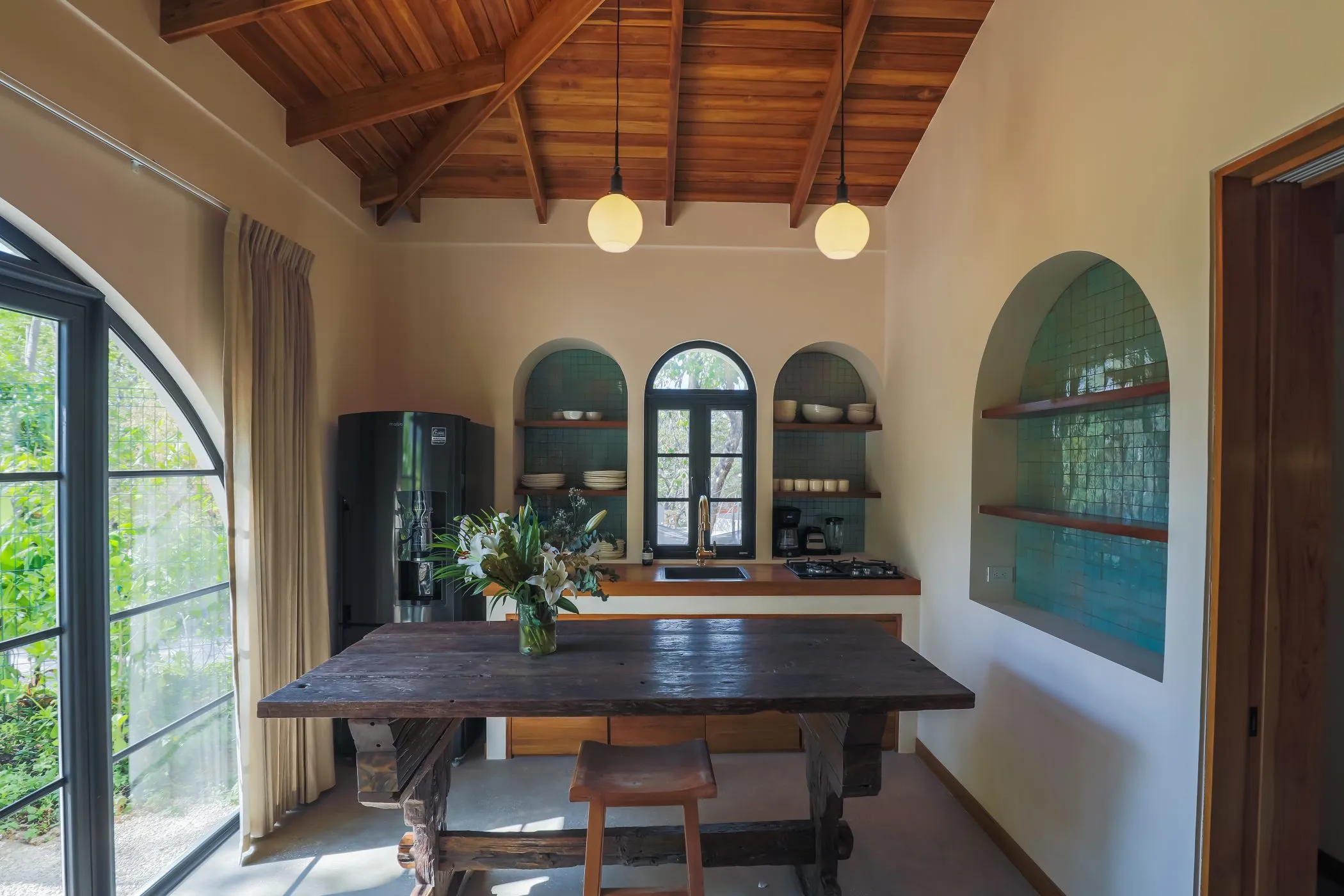 Casa Oceanus villa bedroom with arched window and hacienda finishes, Nosara