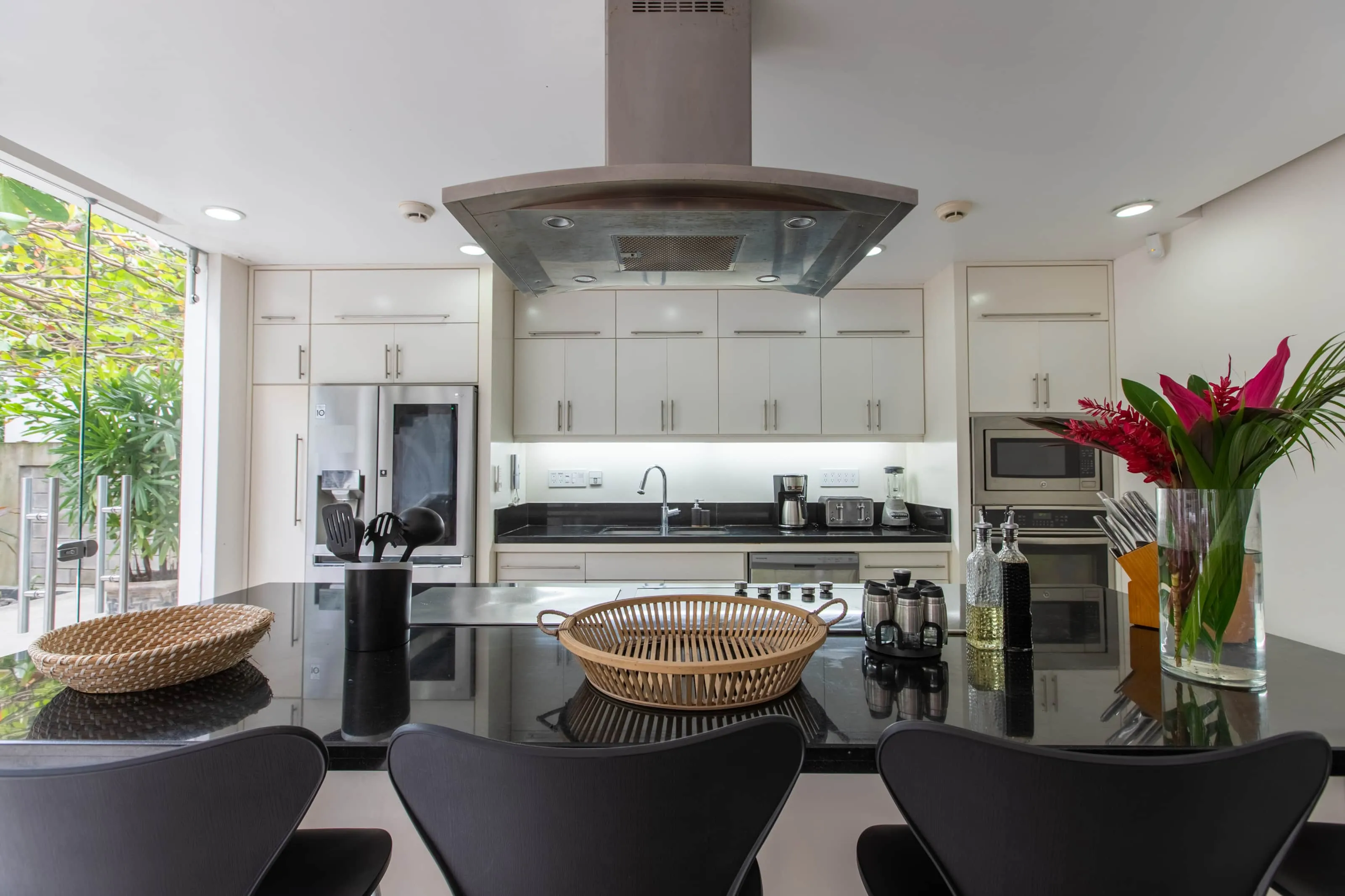 Casa Almendra villa kitchen with cooking island and stainless hood, Nosara