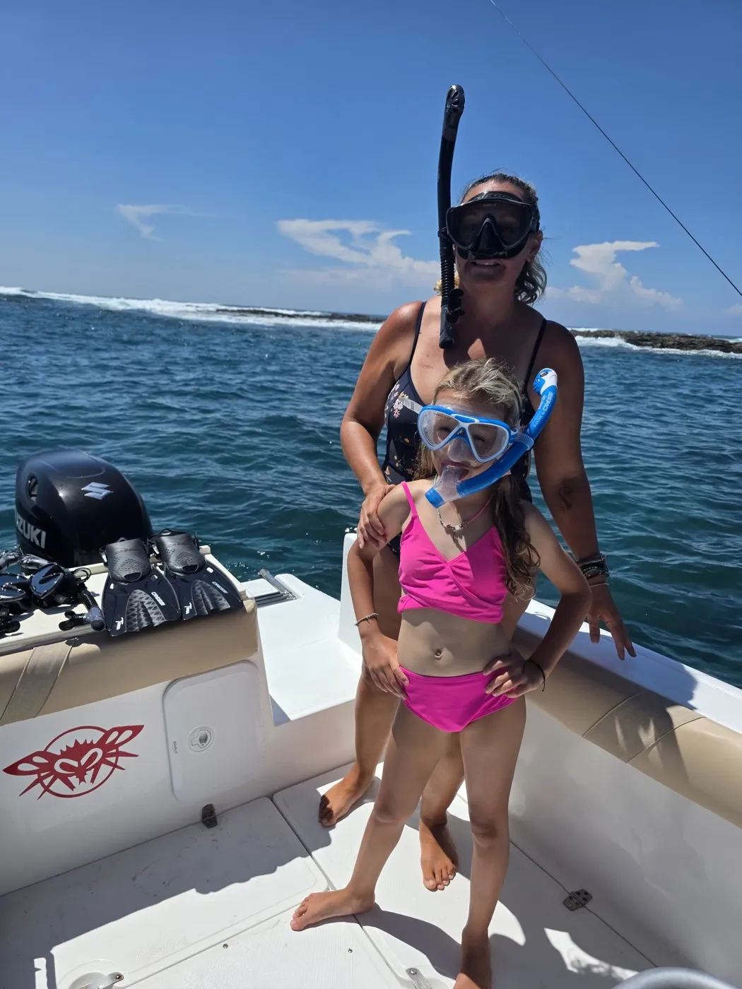 Mother and daughter in snorkel masks on the boat before the snorkel stop